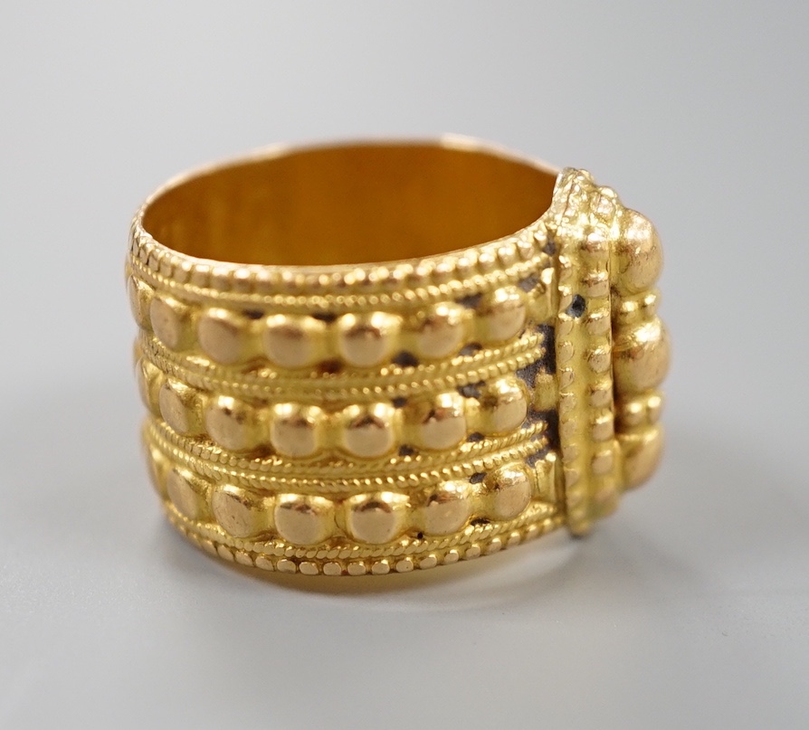 A Middle Eastern embossed yellow metal ring, size O/P, 14.8 grams.